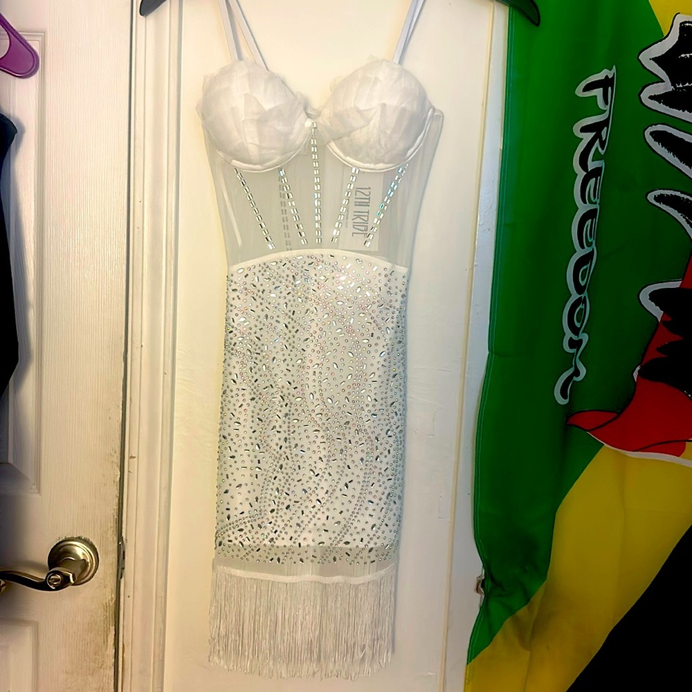 white Mini Dress decorated with stylish embellishments.